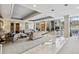 Elegant living room featuring a tray ceiling, neutral tones, and large windows offering abundant natural light at 1900 E Girard Pl # 907, Englewood, CO 80113