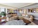 Cozy living room features an over-sized sectional sofa, wood floors, and abundant natural light at 1900 E Girard Pl # 907, Englewood, CO 80113