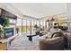 Spacious living room featuring a cozy fireplace, large windows, and comfortable seating with bright, natural light at 1900 E Girard Pl # 907, Englewood, CO 80113