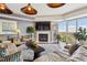 Inviting living room showcasing a brick fireplace, hardwood floors, and natural light from expansive windows at 1900 E Girard Pl # 907, Englewood, CO 80113
