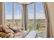 Reading nook area with comfortable floral chaise and a stunning view of the city skyline at 1900 E Girard Pl # 907, Englewood, CO 80113