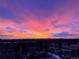 Expansive skyline view featuring a vibrant sunset over the Denver area at 1900 E Girard Pl # 907, Englewood, CO 80113