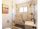 Modern bathroom with marble-style tile, glass shower, and sleek fixtures at 500 S Pennsylvania St # 520, Denver, CO 80209