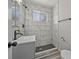 Bathroom featuring a tiled shower, modern fixtures, and a stylish vanity at 500 S Pennsylvania St # 520, Denver, CO 80209