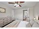 Well-lit bedroom with a ceiling fan, hardwood floors, and an en suite bathroom at 500 S Pennsylvania St # 520, Denver, CO 80209