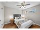 Comfortable bedroom with hardwood floors, soft lighting, and a decorative ceiling fan at 500 S Pennsylvania St # 520, Denver, CO 80209