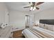 Spacious bedroom featuring hardwood floors, a ceiling fan, and an attached bathroom at 500 S Pennsylvania St # 520, Denver, CO 80209