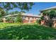 Well-maintained brick building with a lush green lawn and mature landscaping at 500 S Pennsylvania St # 520, Denver, CO 80209