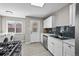 Well-lit kitchen with sleek, dark backsplash, stainless steel appliances, and tile flooring at 500 S Pennsylvania St # 520, Denver, CO 80209