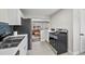 A modern kitchen featuring stainless steel appliances with open view to the stylish living room at 500 S Pennsylvania St # 520, Denver, CO 80209