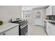 Bright kitchen with a modern gas range, stainless steel appliances, and easy access to laundry at 500 S Pennsylvania St # 520, Denver, CO 80209