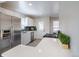 Bright kitchen featuring stainless steel appliances, white cabinetry, and a stylish tile backsplash at 500 S Pennsylvania St # 520, Denver, CO 80209