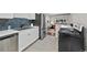 Modern kitchen with stainless steel appliances, white cabinets, and attractive blue backsplash tiles at 500 S Pennsylvania St # 520, Denver, CO 80209