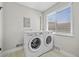 Laundry room with a window, a pair of LG appliances, and tiled flooring at 500 S Pennsylvania St # 520, Denver, CO 80209