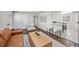 Stylish living room with breakfast bar to kitchen, hardwood floors, contemporary furniture, and modern decor at 500 S Pennsylvania St # 520, Denver, CO 80209