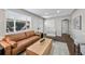 Bright living room featuring a leather sofa, modern decor, hardwood floors and abundant natural light at 500 S Pennsylvania St # 520, Denver, CO 80209