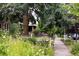 Street view featuring a sidewalk bordered by a flower garden and lush foliage at 500 S Pennsylvania St # 520, Denver, CO 80209