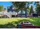 Backyard view of home with landscaped lawn, wooden fence and firepit at 9924 Silver Maple Way, Highlands Ranch, CO 80129
