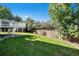 Lush green lawn with a view of home's deck and a wooden fence at 9924 Silver Maple Way, Highlands Ranch, CO 80129
