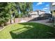 Backyard view with a small patch of lawn, wooden fence, and gravel section at 9924 Silver Maple Way, Highlands Ranch, CO 80129