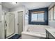 Bathroom showcasing separate shower and jacuzzi tub with tile surround and dark blue accent wall at 9924 Silver Maple Way, Highlands Ranch, CO 80129