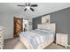 Bedroom with gray walls, light carpet, wooden sliding door and visible ensuite bath with white vanity at 9924 Silver Maple Way, Highlands Ranch, CO 80129