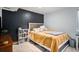 A cozy bedroom featuring stylish decor, warm lighting, and a comfortable bed with decorative pillows at 9924 Silver Maple Way, Highlands Ranch, CO 80129