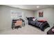 Well lit bedroom featuring a desk area, bed and carpet flooring with a window to bring in natural light at 9924 Silver Maple Way, Highlands Ranch, CO 80129