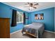 Bedroom with blue walls, a modest bed, dark curtains, and eclectic artwork, a cozy retreat at 9924 Silver Maple Way, Highlands Ranch, CO 80129