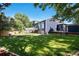 Beautiful backyard view of home with a well-manicured lawn and exterior deck at 9924 Silver Maple Way, Highlands Ranch, CO 80129
