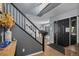Welcoming home foyer showcasing hardwood floors, gray walls, and a staircase with stylish black and white railings at 9924 Silver Maple Way, Highlands Ranch, CO 80129