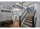 Elegant foyer with beautiful hardwood floors and staircase leading to the upper level with sleek black and white railings at 9924 Silver Maple Way, Highlands Ranch, CO 80129