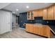 A stylish kitchenette area boasts warm wooden cabinets and a sleek countertop with ample storage at 9924 Silver Maple Way, Highlands Ranch, CO 80129