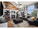 Cozy living room boasts vaulted ceilings, fireplace, and large windows with lots of natural light at 9924 Silver Maple Way, Highlands Ranch, CO 80129
