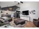Inviting living room with TV, fireplace, comfortable seating, and staircase at 9924 Silver Maple Way, Highlands Ranch, CO 80129