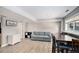Spacious living room area with a comfortable sofa, dining table and light hardwood flooring at 9924 Silver Maple Way, Highlands Ranch, CO 80129