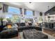 Open-concept living space with large windows, spacious seating area, and adjacent dining area at 9924 Silver Maple Way, Highlands Ranch, CO 80129