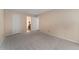 Large bedroom with neutral walls, carpet, and open doorway to the ensuite bathroom at 3600 S Pierce St # 5-101, Denver, CO 80235