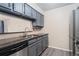 Stylish kitchen showcasing stainless steel appliances and grey painted cabinets at 3600 S Pierce St # 5-101, Denver, CO 80235