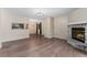 Open-concept living room with a stone fireplace and seamless kitchen access at 3600 S Pierce St # 5-101, Denver, CO 80235
