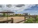 Outdoor community space with picnic tables, a food truck, and fenced area at 7744 S Cherokee Trl, Centennial, CO 80016
