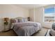 Bright bedroom features a cozy queen bed with bedside tables and city views at 1020 15Th St # 42A, Denver, CO 80202