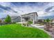 Wide view of the backyard featuring the patio, lawn, and garden at 11821 Discovery Ln, Parker, CO 80138