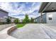 Well-maintained backyard featuring a concrete patio, stone bench, and mature landscaping at 11821 Discovery Ln, Parker, CO 80138