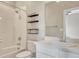 Bright bathroom featuring a shower-tub combo, floating shelves and a granite topped vanity at 11821 Discovery Ln, Parker, CO 80138