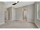 Spacious bedroom with carpet, a ceiling fan, natural light and an en suite bathroom at 11821 Discovery Ln, Parker, CO 80138