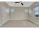 Neutral bedroom with a carpeted floor, ceiling fan, and lots of natural light at 11821 Discovery Ln, Parker, CO 80138