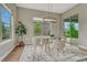 Bright dining room with modern light fixture, glass table, and plush rug at 11821 Discovery Ln, Parker, CO 80138