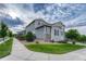 Exterior elevation of a well maintained home with a manicured lawn and sidewalk at 11821 Discovery Ln, Parker, CO 80138