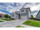 Inviting two-story home featuring a wide driveway, attached two-car garage and nicely manicured lawn at 11821 Discovery Ln, Parker, CO 80138